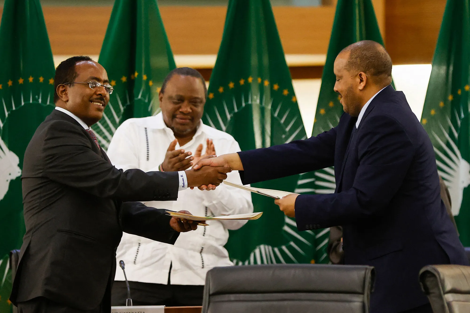 Redwan Hussein,&nbsp;left, Representative of the Ethiopian government, and Getachew Reda, right, Representative of the Tigray People's Liberation Front, shake hands during a meeting regarding the African Union-led negotiations to resolve conflict in Ethiopia, in Pretoria on Nov.&nbsp;2.&nbsp;