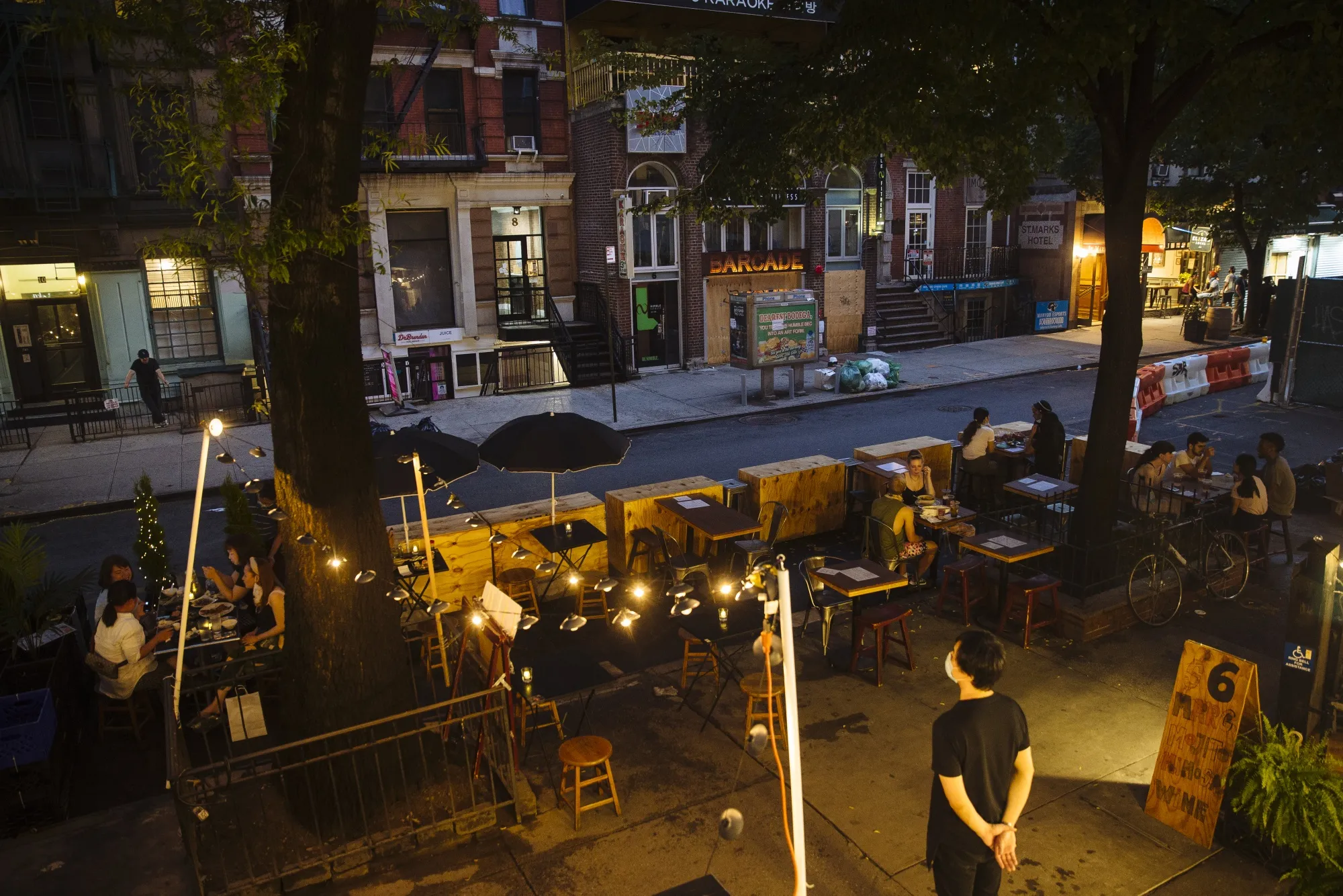 People sit outside restaurants at St. Marks Place in New York on July 6.