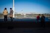 Visitors look out from an observation deck at Haneda Airport in Tokyo, Japan, on Sunday, Oct. 25, 2020. The global airline industry is facing a painfully slow recovery from the ongoing effects of the pandemic as carriers slash jobs and secure funds to ride out the crisis.