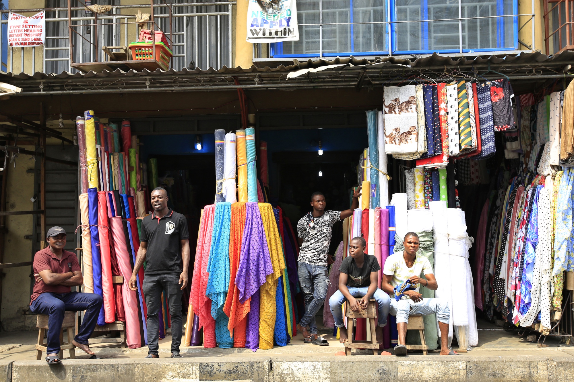 Vendors sit in stalls in Lagos, Nigeria.