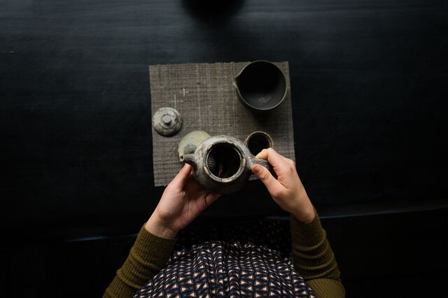 A person holds a tea set from the Maana Atelier, which offers small-group workshops for everything from botanical teas to earthen wall art.