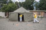 Volunteers enter a temporary medical tent at a clinic during a deep cleaning operation in&nbsp;Johannesburg.