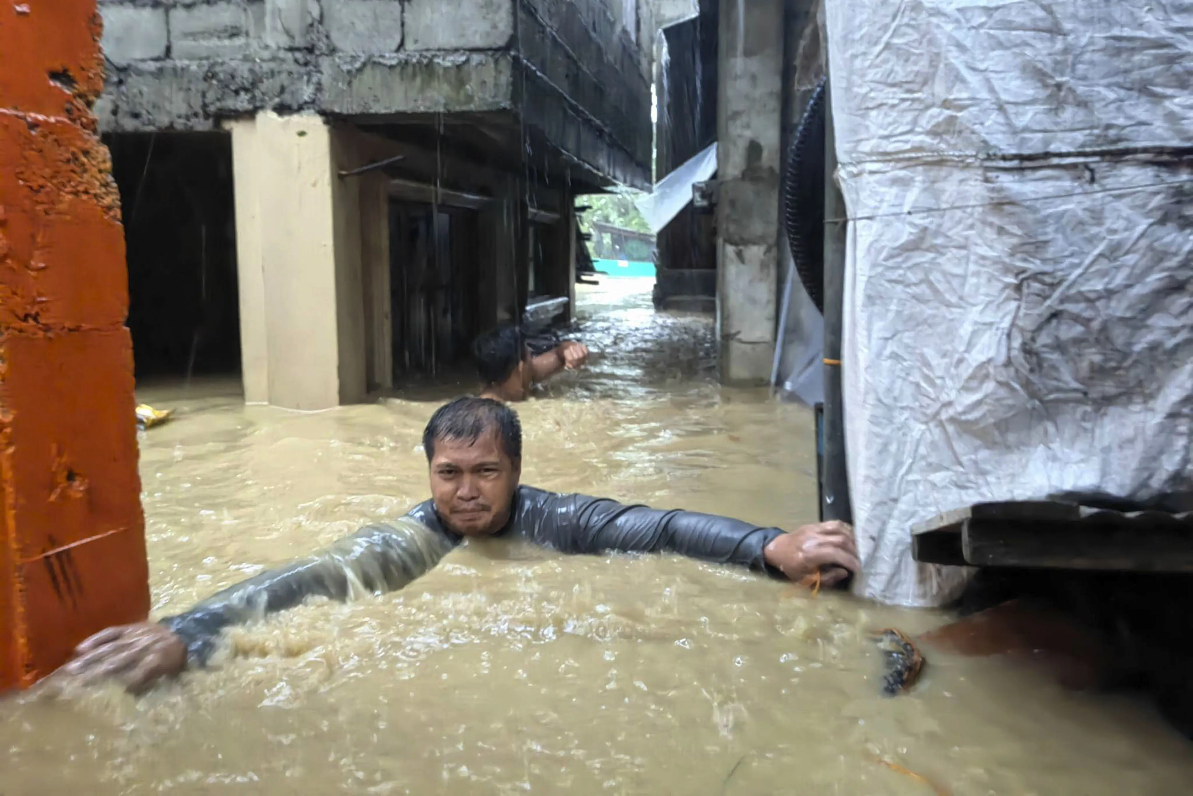 A man negotiates floodwaters in his village caused by Typhoon Doksuri in northern Philippines on July 26.
