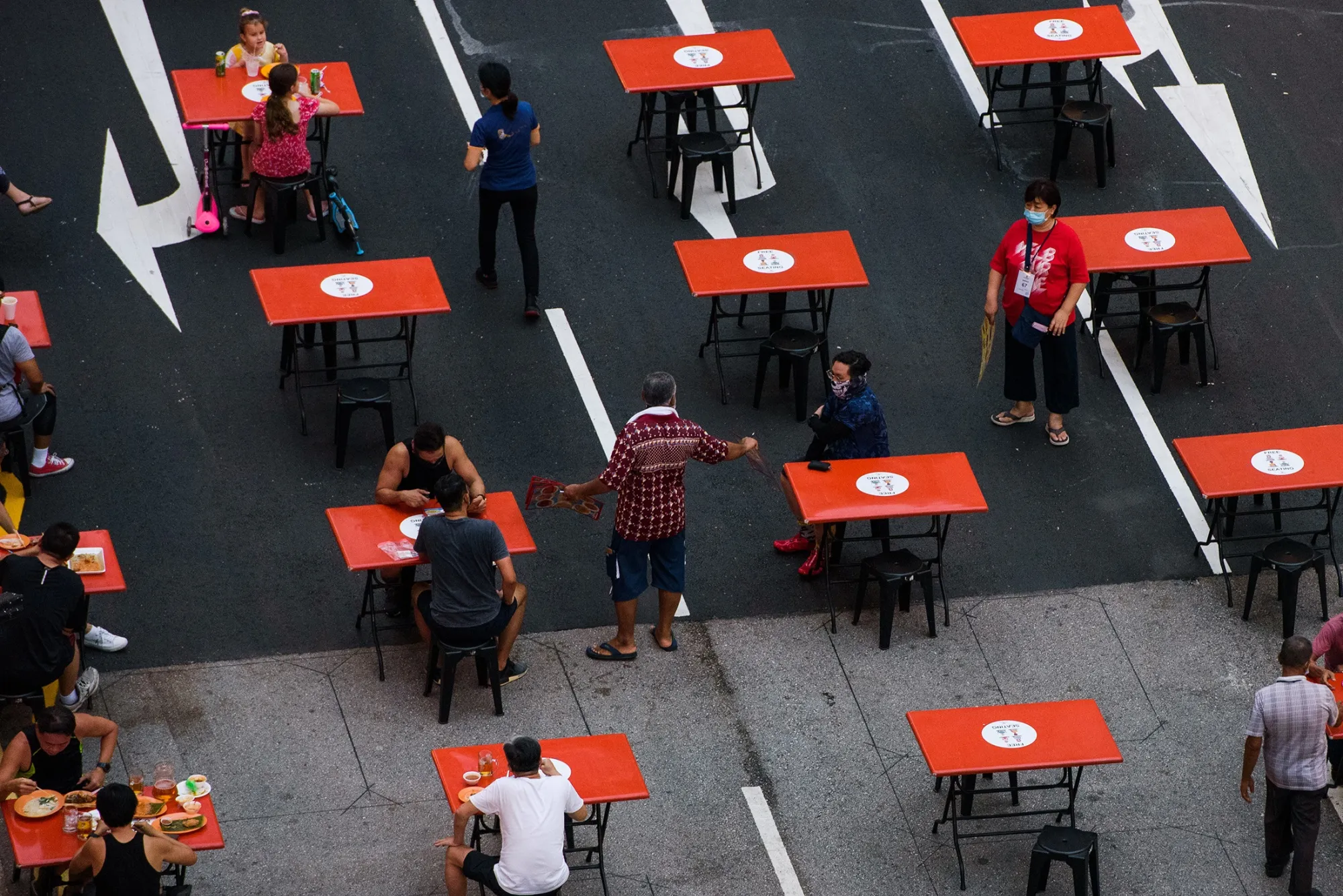 People seated in groups of 2 as mandated by Covid-19 safety restrictions at a food centre in Singapore, earlier in October. 