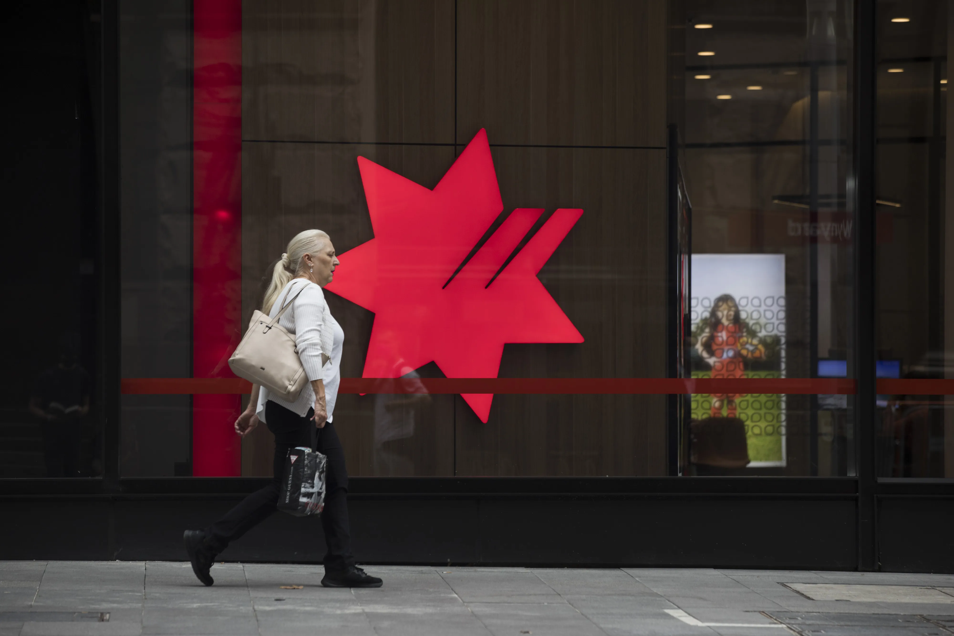 A pedestrian passes a National Australia Bank&nbsp;branch in Sydney, Australia.
