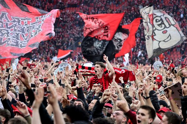 Bayer Leverkusen fans celebrate winning the Bundesliga title for the first time on April 14.