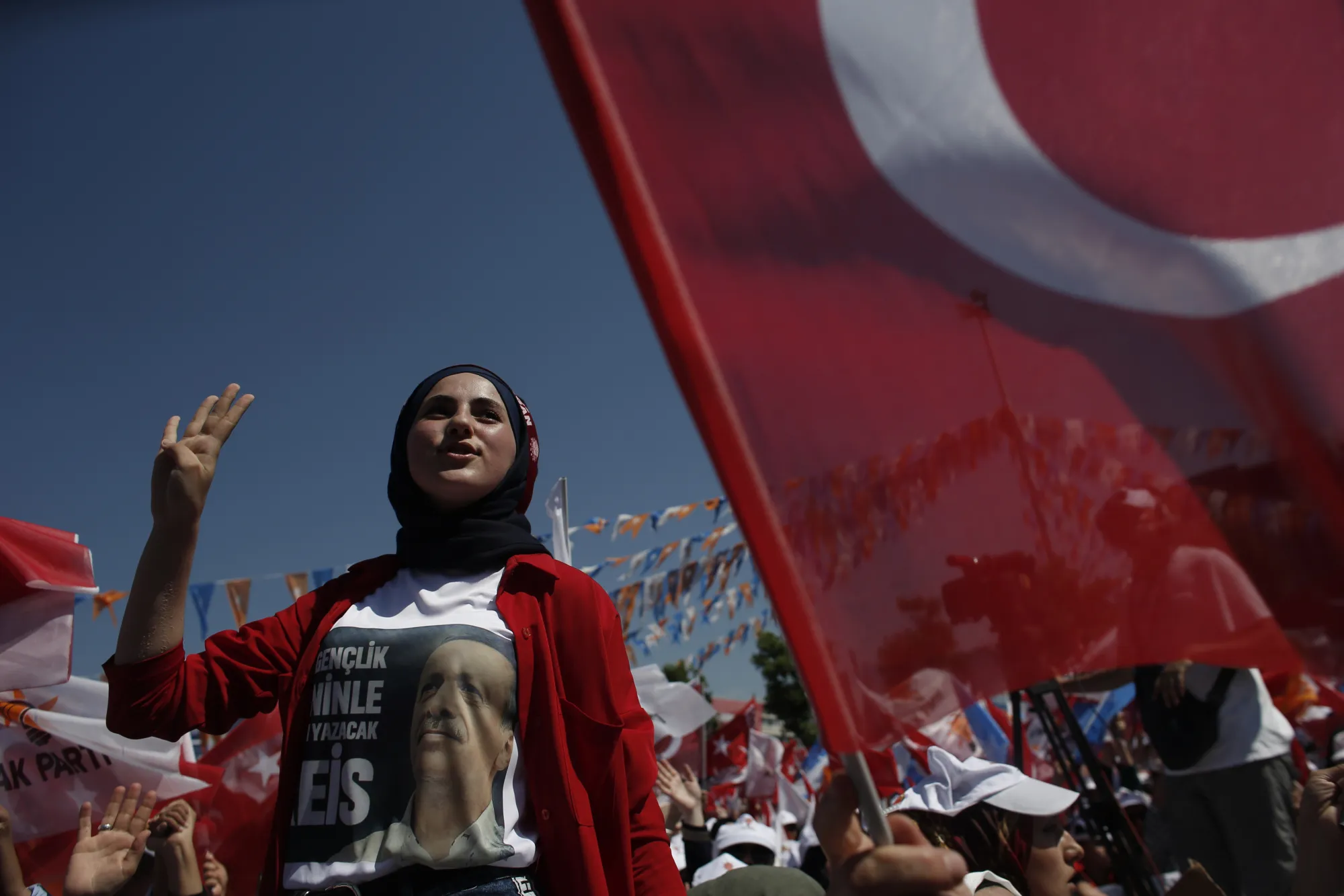 A woman wears a shirt displaying an image of Recep Tayyip Erdogan, Turkey's President, and gestures during an election campaign rally in Yalova, Turkey, on&nbsp;June 14, 2018.
