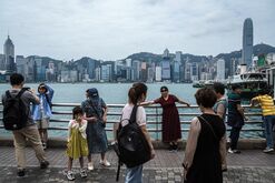 Tourists on the promenade in the Tsim Sha Tsui area of Hong Kong