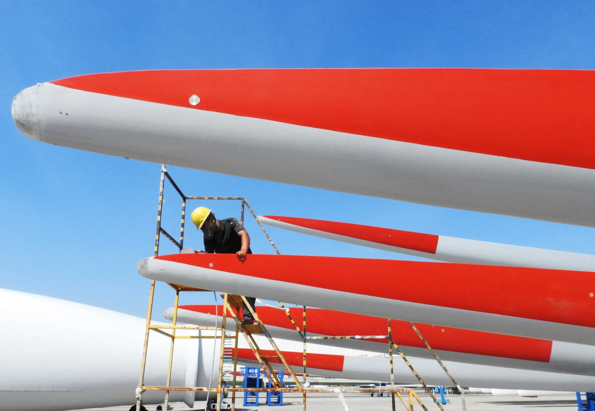 A worker checks the quality of&nbsp;wind turbine blades at a factory in Lianyungang, China.