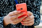 A customer looks at an Apple iPhone 5c device during the launch at the company's new store in Palo Alto, California, on Sept. 20