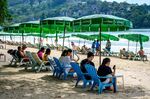 Tourists lounge at Patong Beach on the Thai island of Phuket.&nbsp;