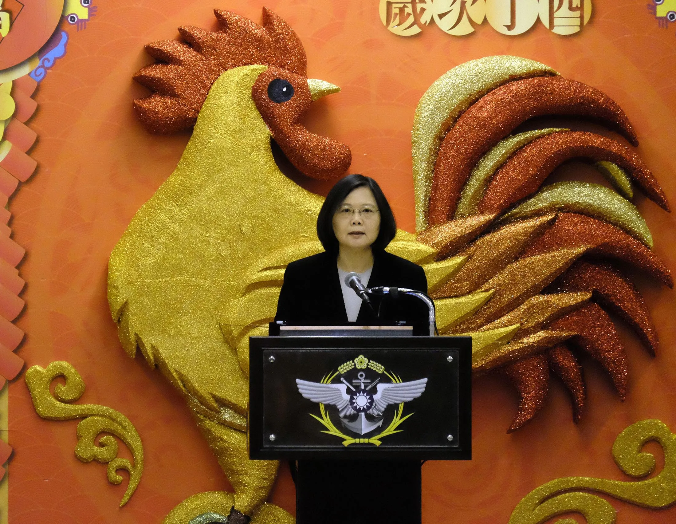 Taiwan President Tsai Ing-wen speaks in front of a 'Year of the Rooster' decoration in Taipei.
