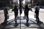 Pedestrians carry shopping bags in San Francisco.