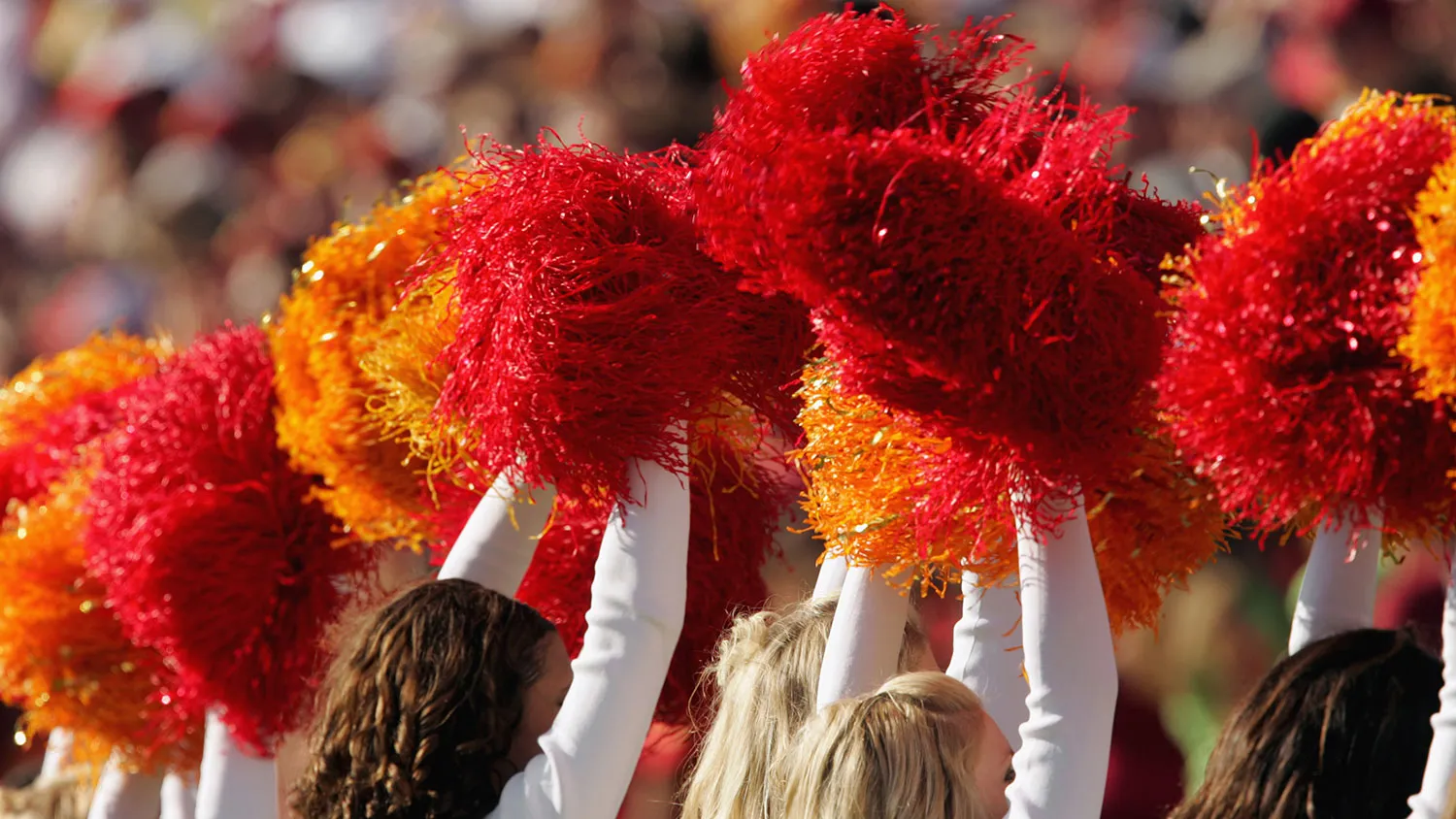 Members of the USC Song Girls squad perform with cardinal and gold pompoms during a game against the Washington State Cougars on Oct. 29, 2005, in Los Angeles.
