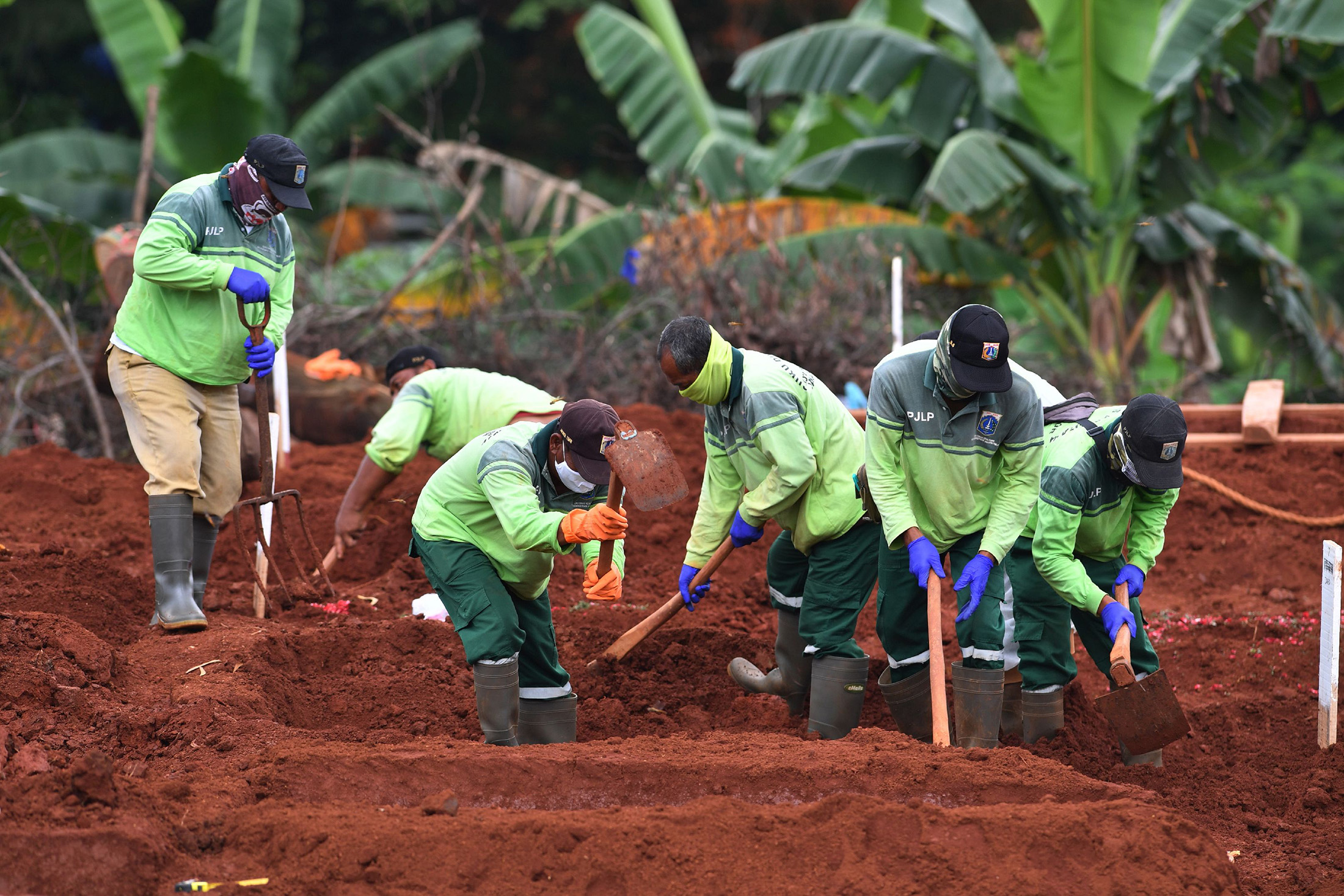 Workers bury a coronavirus victim at a cemetery in Jakarta on May 6.