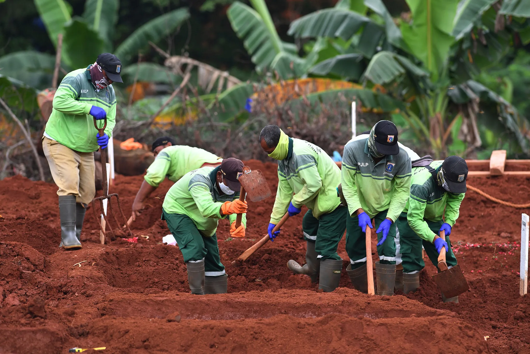 Workers bury a coronavirus victim at a cemetery in Jakarta on May 6.