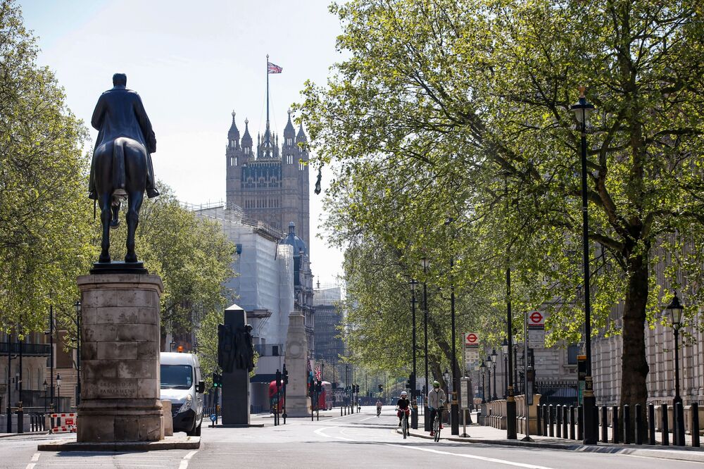 Cyclists pedal along Whitehall in London on April 22.