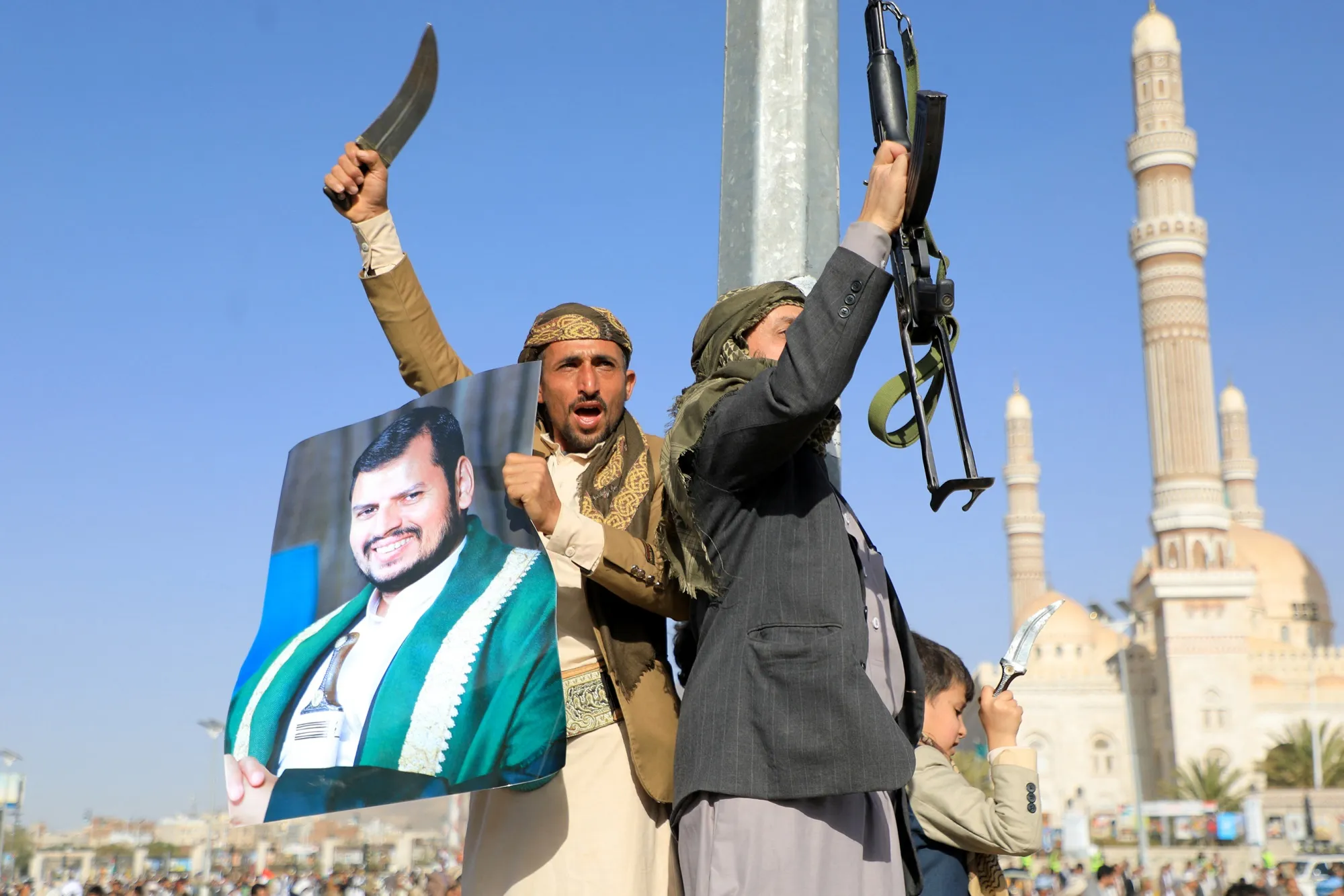 Houthi fighters with a portrait of their leader, Abdul Malik Al-Houthi,&nbsp;during a protest in Sanaa, Yemen.