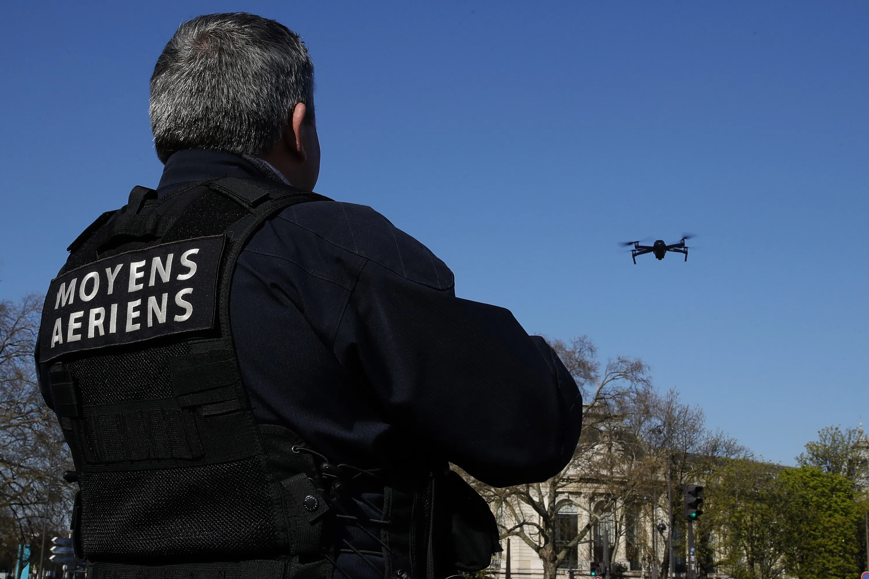 A French Police officer pilots a drone to monitor the street in Paris, in March.