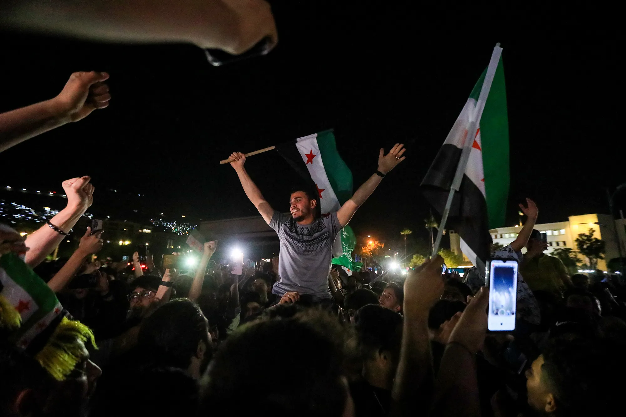 People celebrate in Damascus' Omeyyad square after US President Donald Trump's decision to lift sanctions in Syria, on May 13.