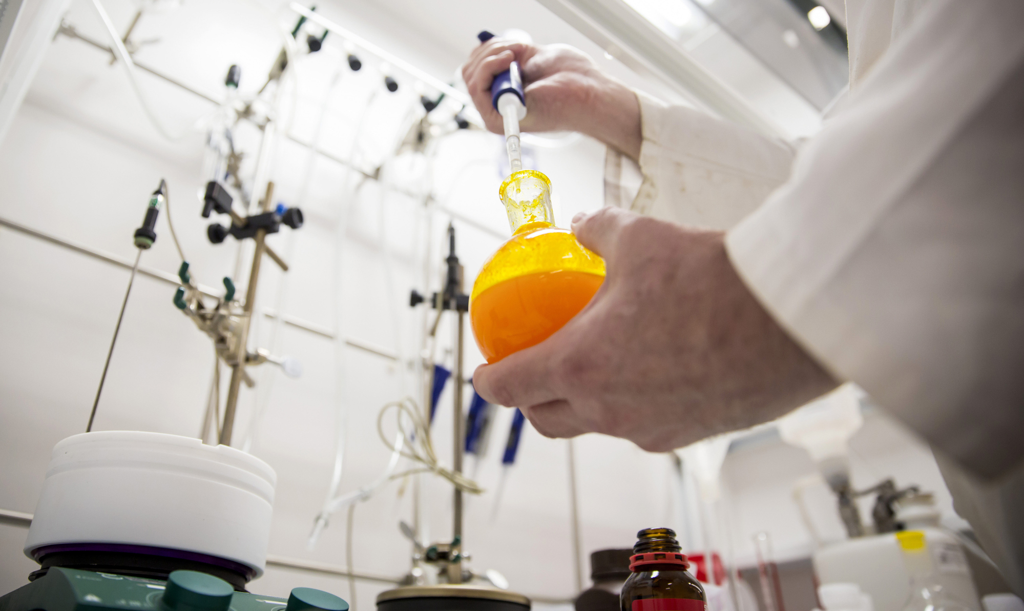 A scientist mixes chemicals inside a&nbsp;GlaxoSmithKline lab.