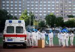 Medical personnel gather at the Guang'an Sport Center to test people who visited or live near Xinfadi Market in Beijing on June 14.