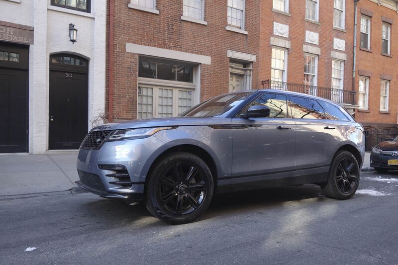 The 2018 Range Rover Velar  parked in front of a brick building.