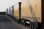 Freight trucks sit parked in a departure lane ahead of boarding a cross-Channel ferry from the Port of Dover Ltd., in Dover, U.K.