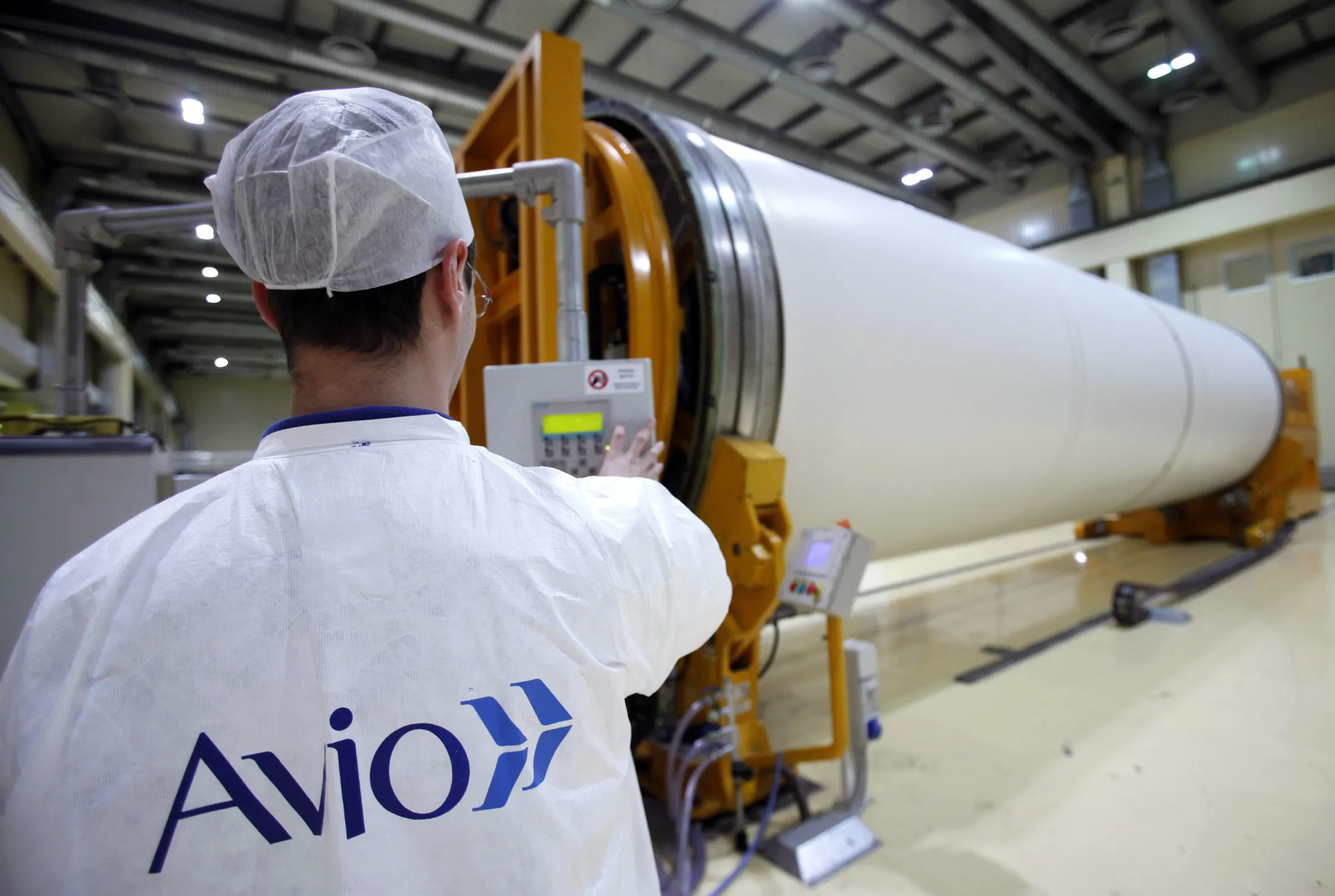 An a worker inspects a segment of an Avio&nbsp;space rocket booster at the company's production plant near Rome.
