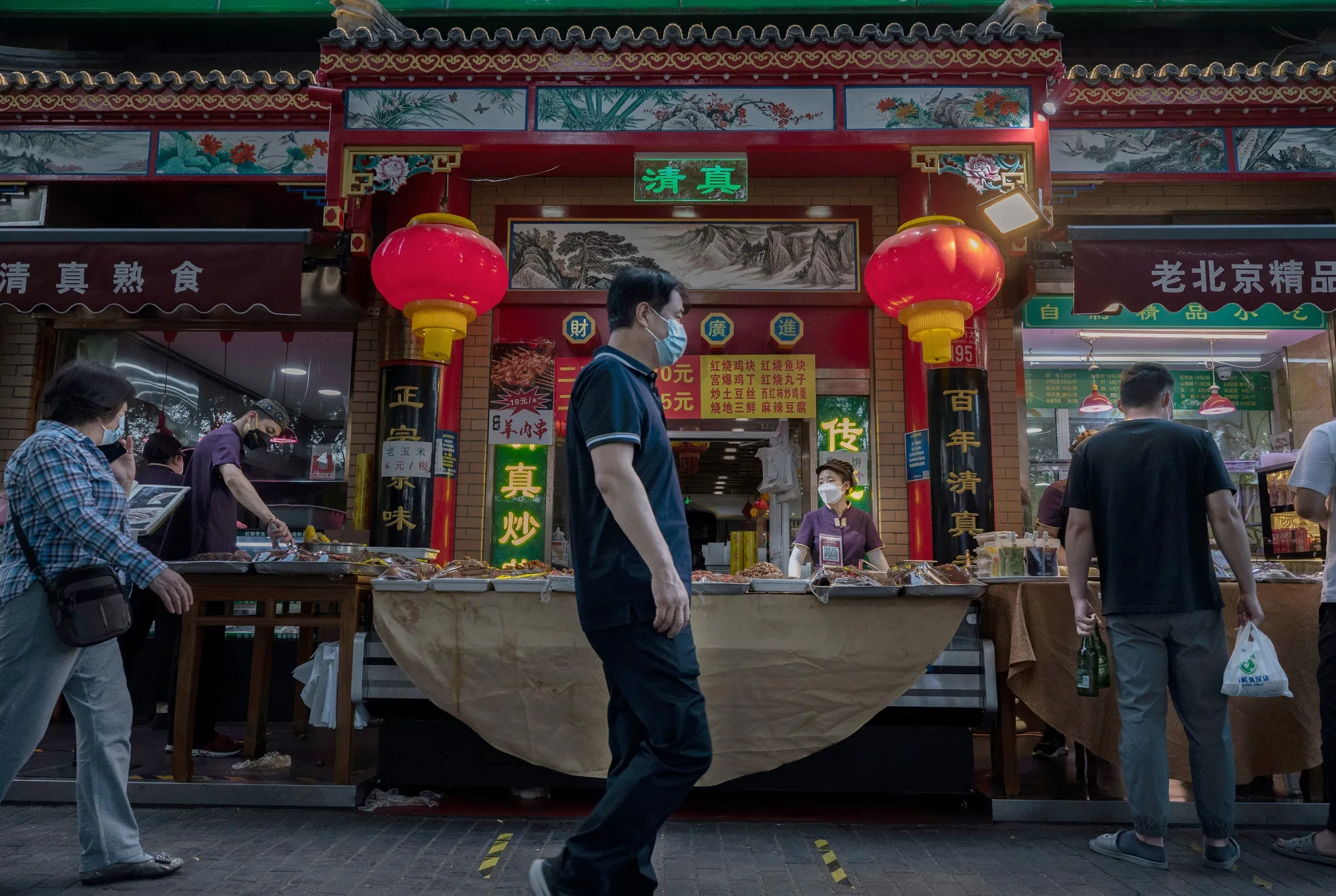 A restaurant worker sells food on the street&nbsp;in Beijing, China.