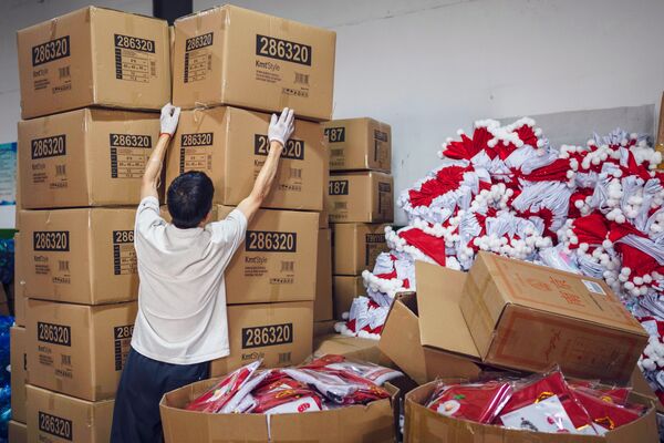 A worker prepares boxes of Christmas decorations in Zhejiang Province, China.