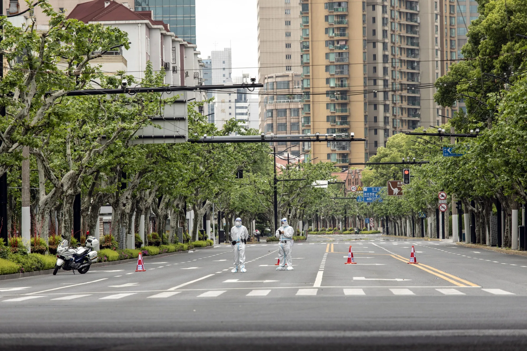 Police officers in protective gear&nbsp;guard a road during a lockdown&nbsp;in Shanghai&nbsp;in April.