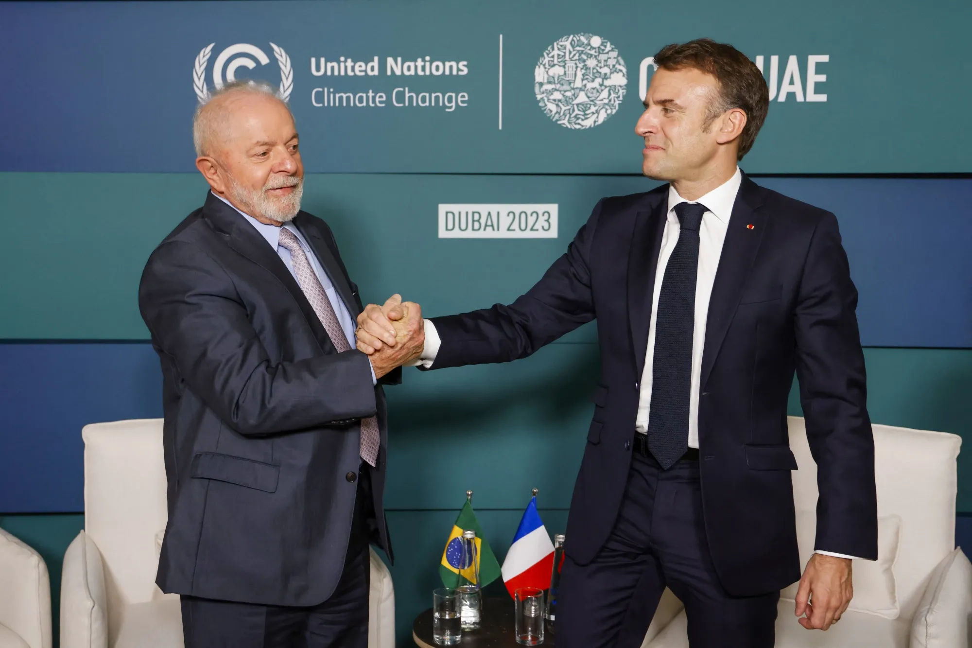 Emmanuel Macron greets Luiz Inacio Lula da Silva&nbsp;on the sidelines of the COP28, on Dec. 2.&nbsp;