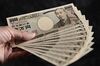 Japanese 10,000 yen banknotes are arranged for a photograph in Kawasaki, Kanagawa Prefecture, Japan, on Tuesday, July 9, 2013. Economists are ditching forecasts for the Bank of Japan to further expand its record easing this year amid signs that a recovering economy may spur inflation.