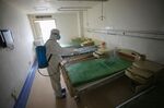 A worker disinfects a room at the Red Cross hospital in Wuhan, on March 18.
