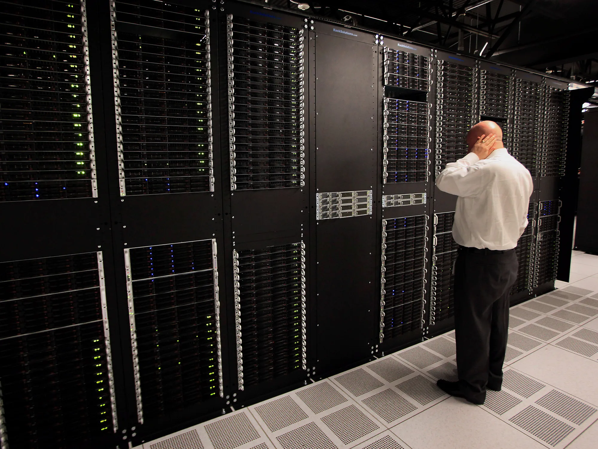 A public relations employee looks over racks of servers inside pod one of International Business Machines Corp.'s (IBM) Softlayer data center in Dallas.
