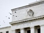 Birds fly past the Marriner S. Eccles Federal Reserve Board building in Washington, D.C.