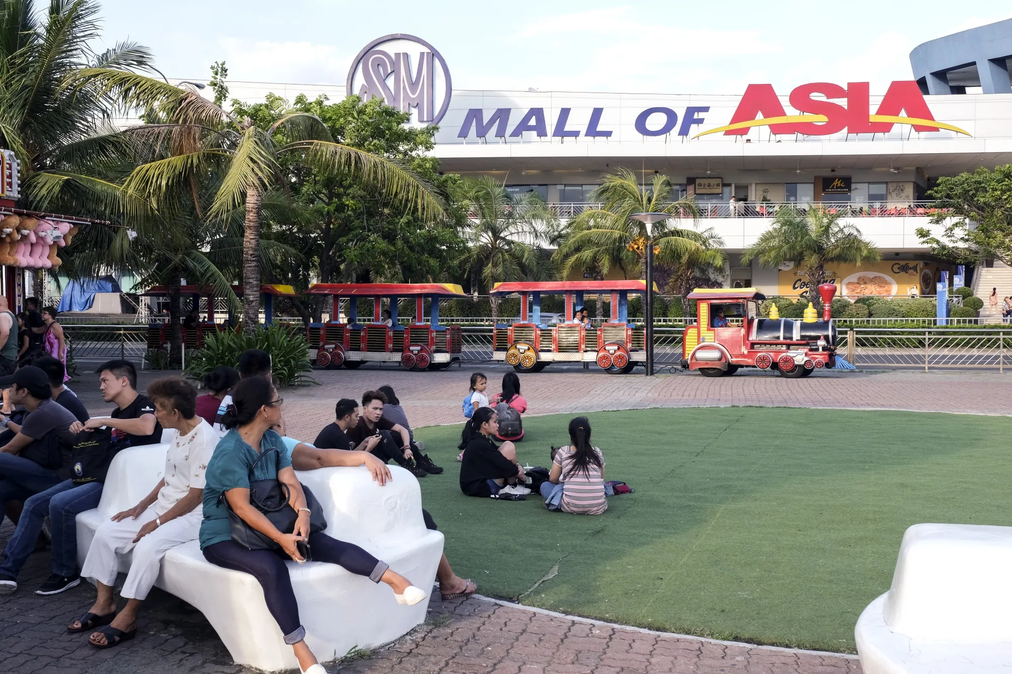 People gather at the SM by the Bay amusement park in the SM Mall of Asia complex in Manila, the Philippines, in 2019.