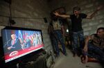 Members of the Iraqi forces react as they watch the US presidential election coverage in Mosul on Nov. 9.
