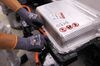 A battery pack is secured on a Volkswagen AG e-Golf electric vehicle on the assembly line in Dresden, Germany.