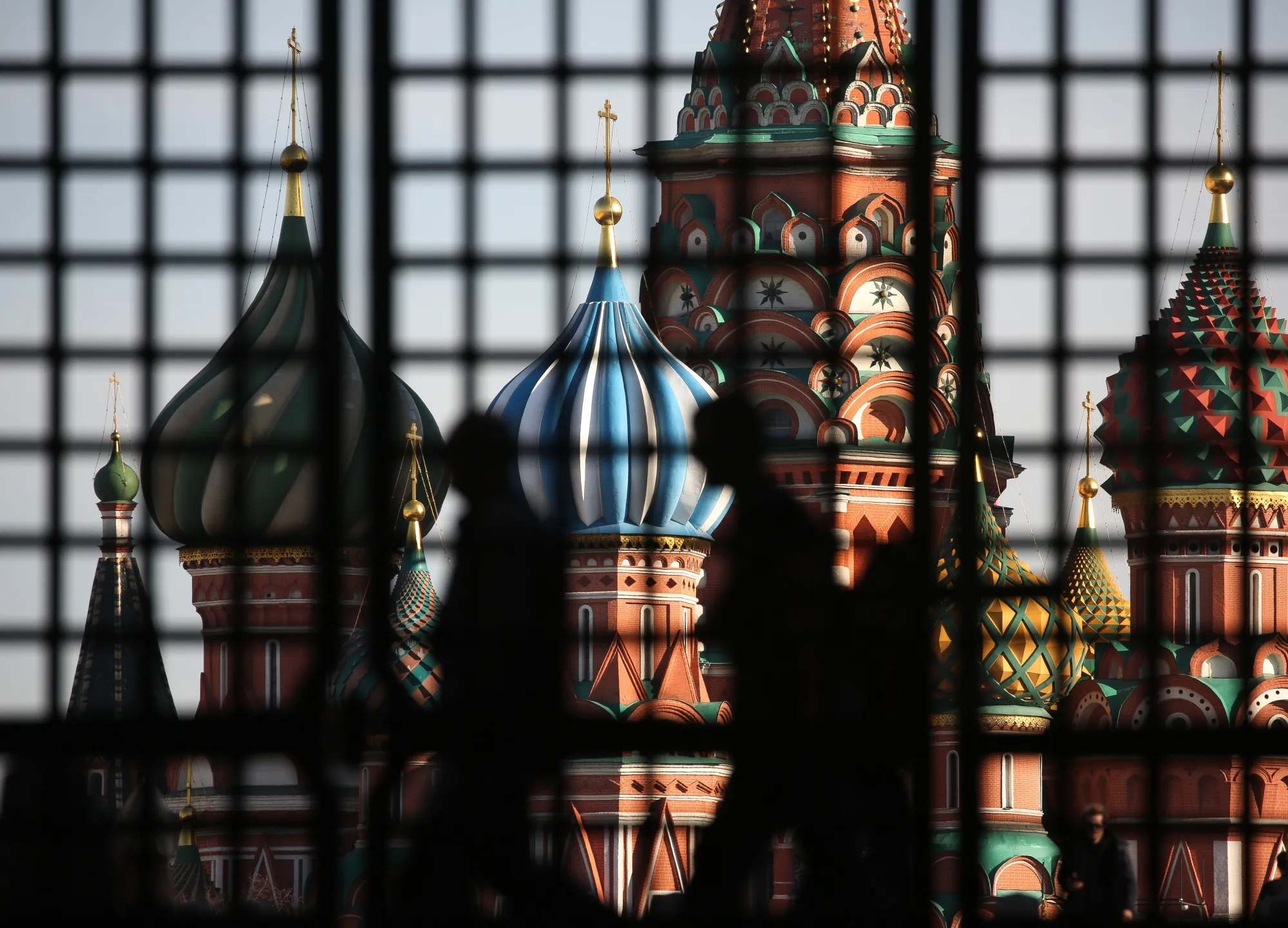 Visitors stand silhouetted near the Kremlin in Moscow on March 26.