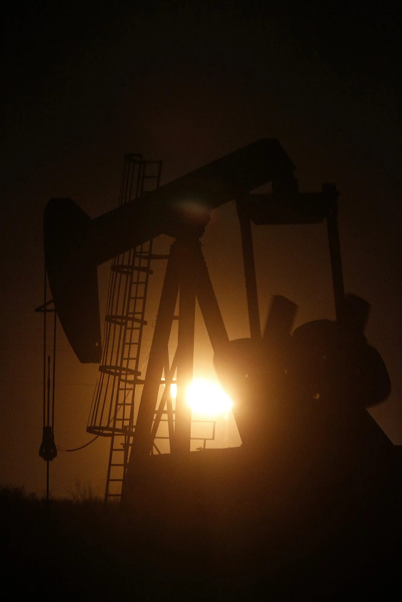 The silhouette of an electric oil pump jack is seen at dusk in the oil fields surrounding Midland, Texas, on&nbsp;Nov. 7, 2017.&nbsp;