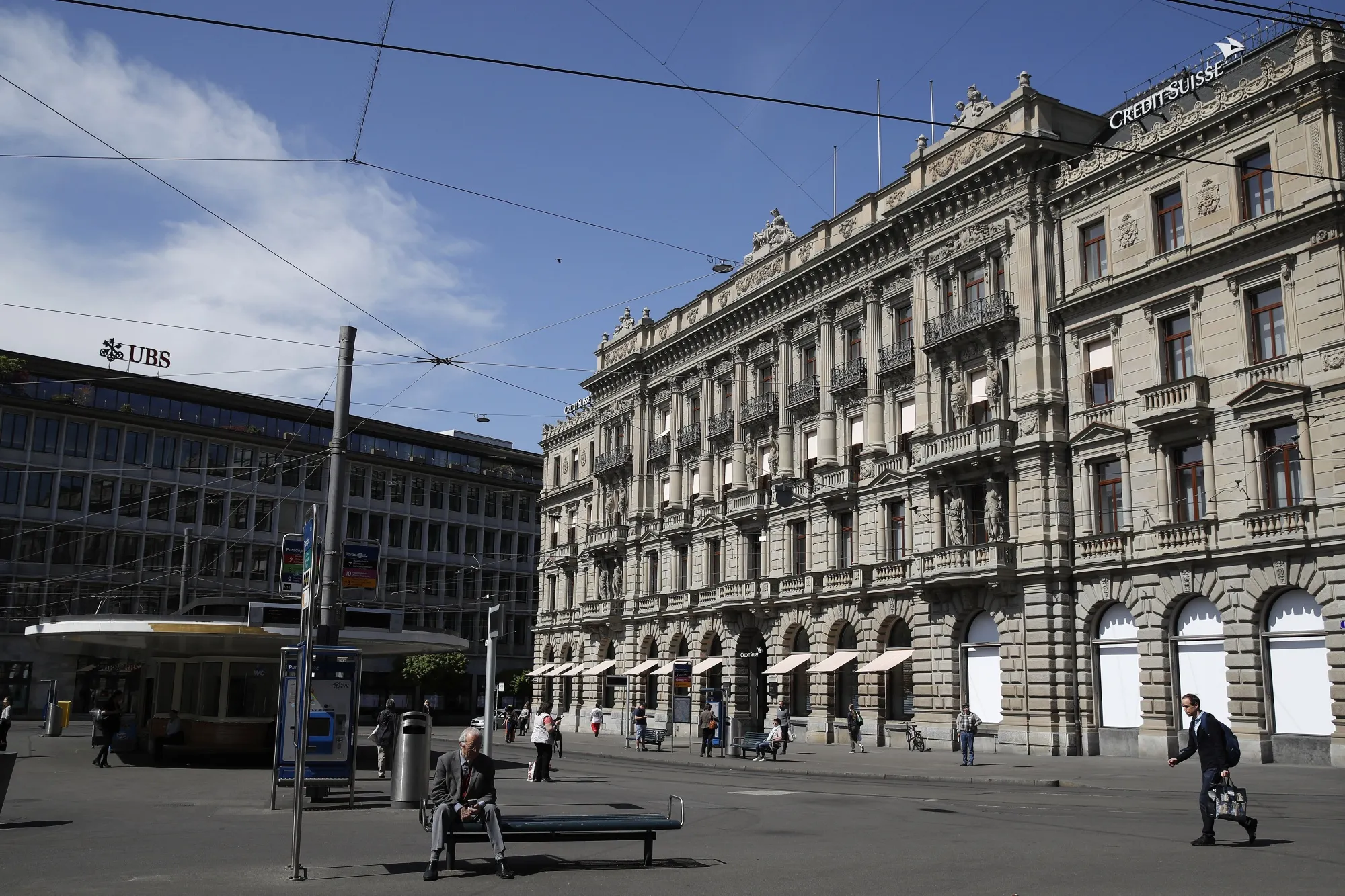 A UBS Group bank branch, left, and the Credit Suisse Group headquarters in Zurich.