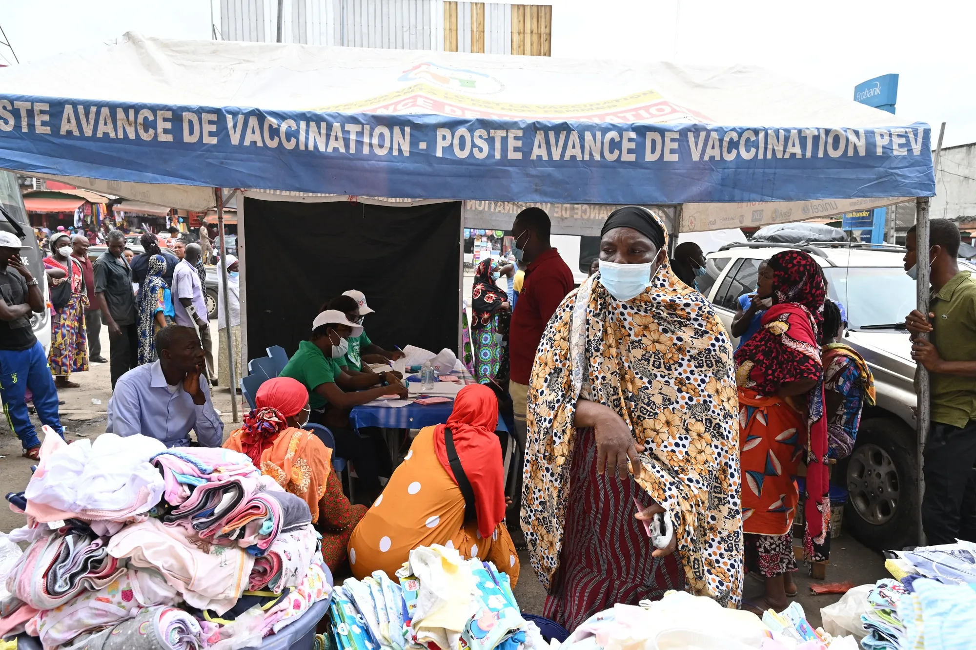 People queue to receive a Pfizer Covid-19 vaccine dose at a market in Abidjan, Ivory Coast.&nbsp;