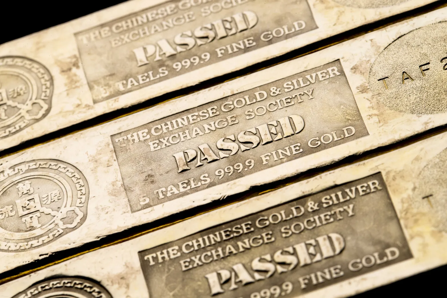 Five tael gold bars are arranged for a photograph at the Chinese Gold and Silver Exchange Society in Hong Kong, China.