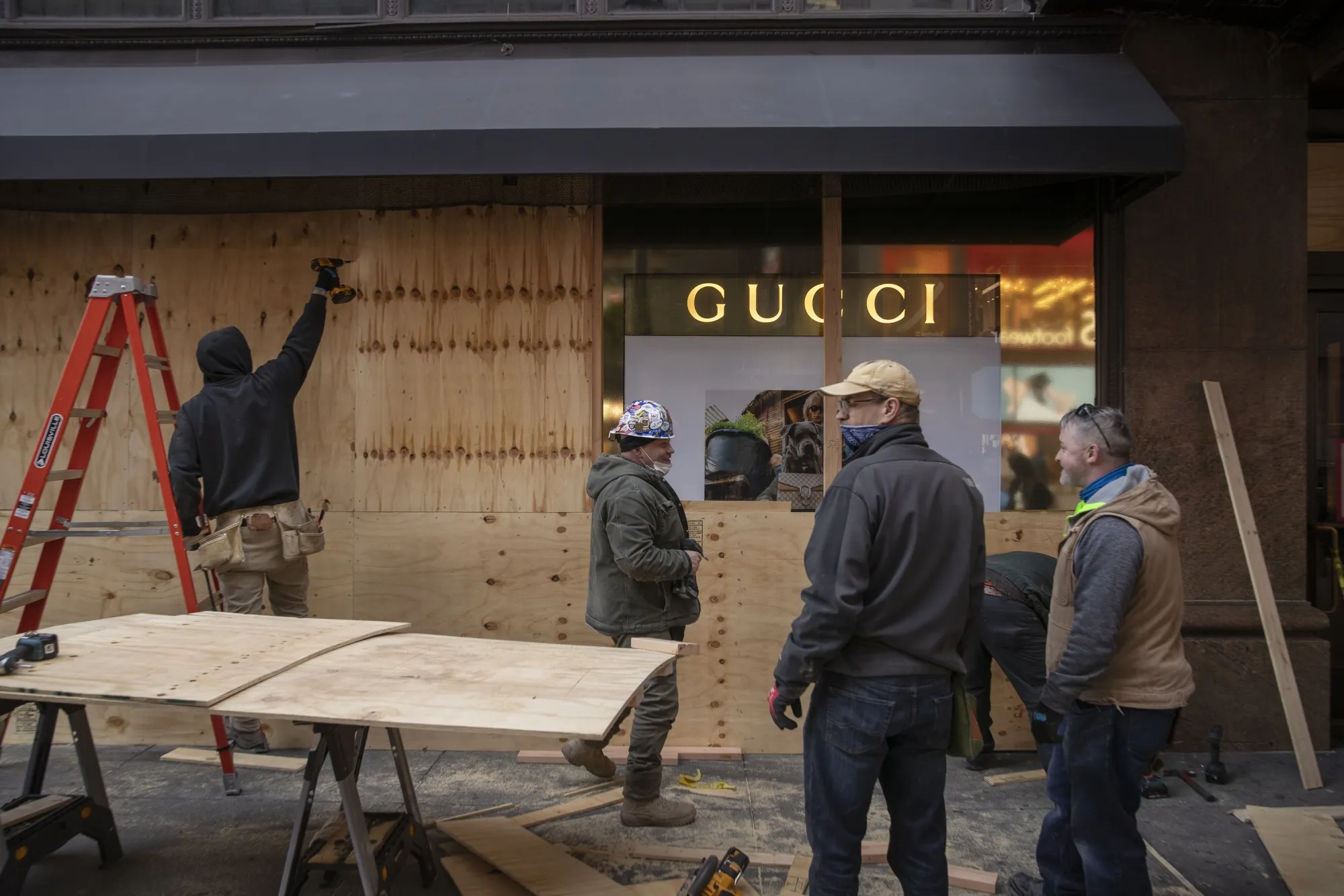Workers board up the windows of the Macy’s Inc. department store in New York, on Oct. 31.