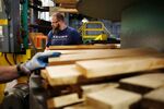 A factory worker wears a U.S. President Donald Trump 'Make America Great Again' campaign shirt while selecting pieces of white oak to be manufactured.
