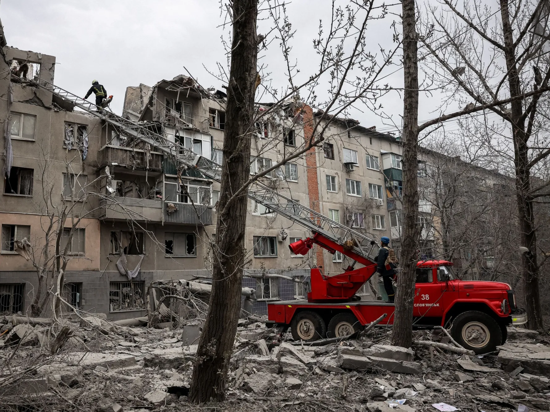 Rescuers work at a site of a partially destroyed residential building after shelling in Sloviansk, Ukraine, on April 14. Russia has repeatedly targeted residential areas in the eastern city and all across the nation during its 14-month long war, killing untold thousands of civilians.