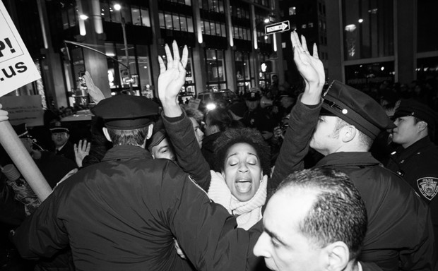 Police force protesters away from the street during a Midtown Manhattan protest against the Eric Garner jury decision in 2014. 