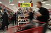 Customers walk past a toy section of a Target in Queens on Nov. 28.